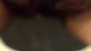 Closeup of Jen peeing into the toilet