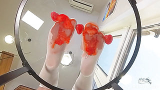 My Nylon Feet Squeezing Strawberry Juice on a Glass Table