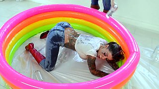 Chanel and Karma with a dildo belt in the oil pool