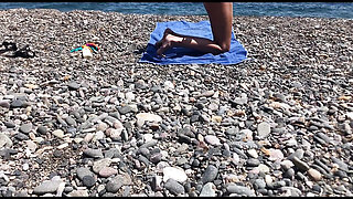 Cute exhibitionist girl get naked in public beach