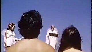Classical nude couple have fun in public beach