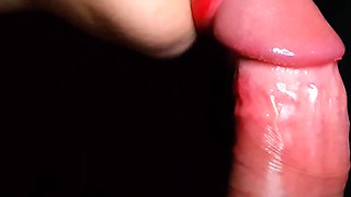 Babe with red lips gently sucks on his dick