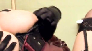 Blonde is on her knees licking busty brunette's cunt