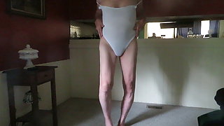 Crossdressing slut in a leotard shakes his womanly ass.