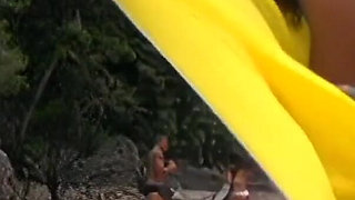 Dark haired beauties enjoy a threesome with a hung hunk on the beach