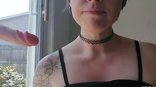Sucking Dildo in Front of Window