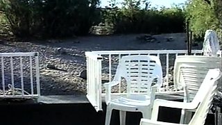 In a kitchen a sexy brunette playing with her big boobs