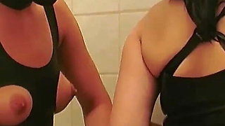 Hot masked babe is having fun with her friend in the bathroom