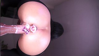 Her creamy Asian ass can be fucked with dildo while I stand watching her