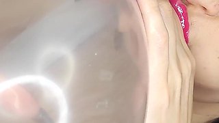 Big-lipped Bimbo Inflates a Condom and Plays with It.