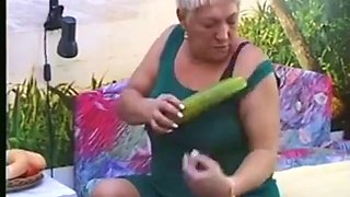 Granny masturbates with cucumber