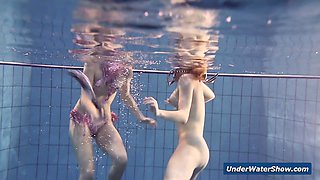 Horny girls strip eachother in the pool
