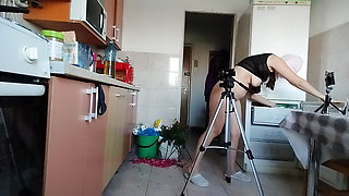 Sexy wife having fun in the kitchen with roses.