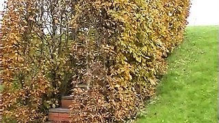 Outdoor solo masturbation scene with curly blonde