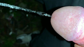 Slowmotion and Close up. Unwashed Uncut Cock Piss on the Ground Outdoor. Long Piss Stream