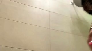 Busty beauty teasingly caresses her wet curves in the shower