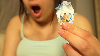 Giantess Girl Unwraps a Candy but Is Surprised Because There Is a Tiny Man in the Candy Bag - She Is Curious to See What It