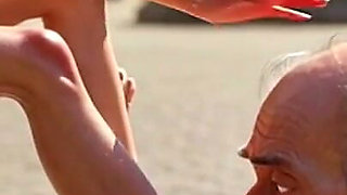 Submissive Man Worshipping Mistress Feet in Public Plaza