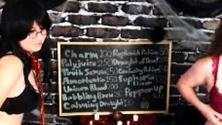 In a kitchen a sexy brunette playing with her big boobs