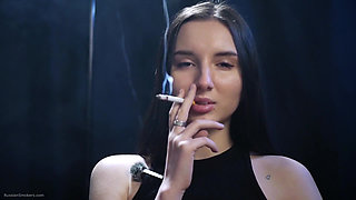 Elegant Brunette Smoking in Black Outfit