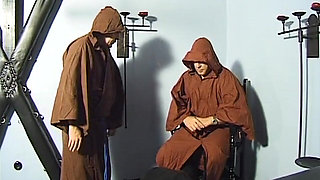 Bound Cougar Teased Relentlessly by Two Hooded Men