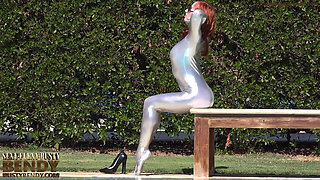 Bending in a Silver Spandex Suit