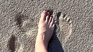 Comparing Size 16 Feet to Sand Prints at the Beach
