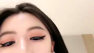 Asian babe sucking and jerking two hard dicks