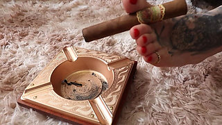 Watch Mistress Mel Fire Smoking Her Cigar with Her Feet