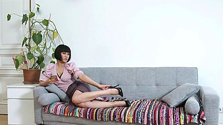 Black Kat plays with her pussy using a vibrator in a pink miniskirt.