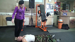 Blonde slut with glasses and her slave in gym