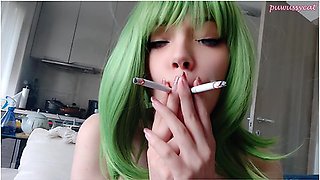 Green-haired girl smokes two cigarettes at once