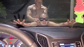 Masked milf gets fucked on a car hood, where her husband sits in there and films it