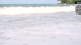 Brown haired doll in a bikini on the beach