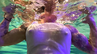 Amazon Kandy Flexes Her Massive Biceps in Her Hotel Pool