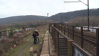 Brunette fucking with old dude next to a railway