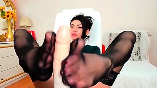 Naty masturbates your cock with her feet in black pantyhose,