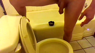 Pissing in the Toilet While Standing on the Bathtub