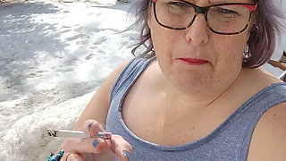 Calm Outdoor Smoking Moment with a Playful Lipstick Look