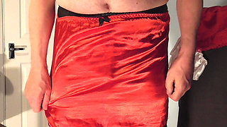Showing  pink panties with red stockings and red satin slip