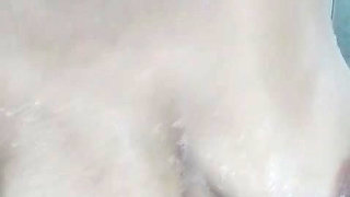 Hot mature woman relaxes in the bathroom and masturbates full of foam under the shower