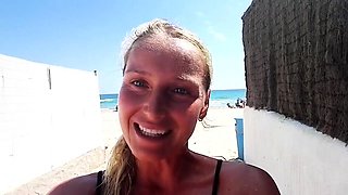 Outdoor solo masturbation scene with curly blonde